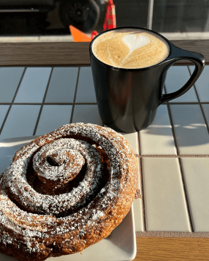 Latte & Cinnamon Scroll at Deville Coffee