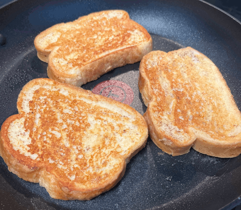 Cooked french toast in a skillet.
